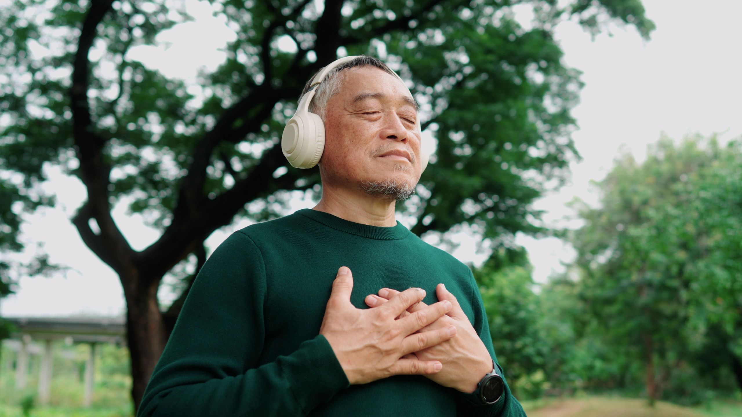 Man outdoors with headphones enjoying nature